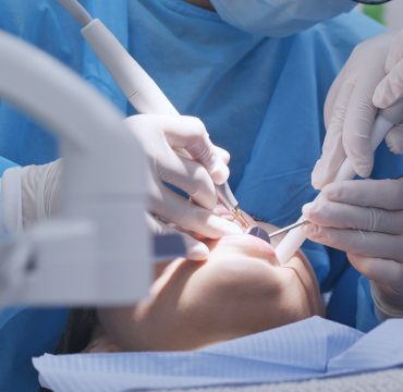 Dentist examines the patient teeth